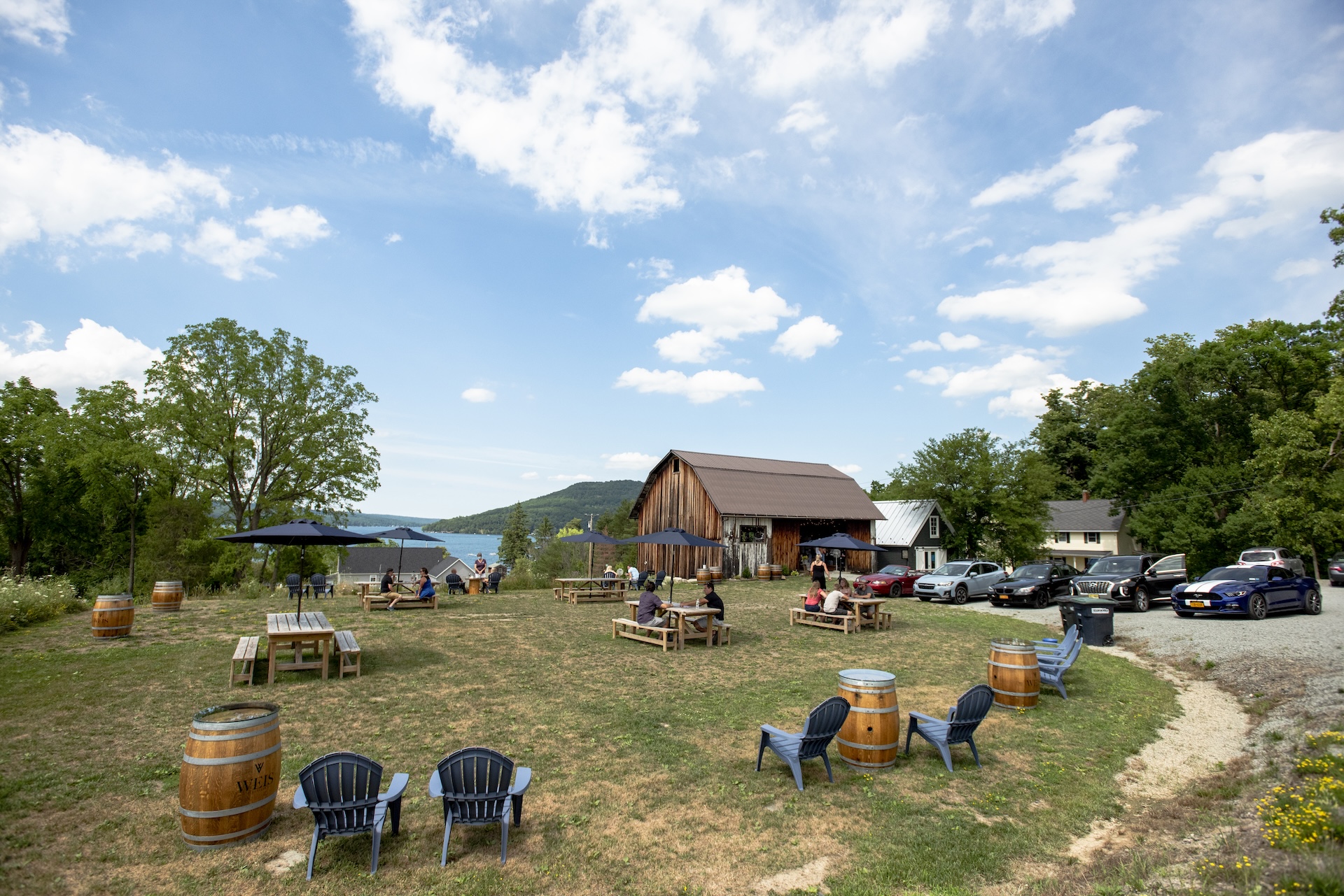 Front view of the tasting room schoolhouse. Showcasing the new blue siding, white sliding barn doors, galvanized metal roof and small square sign on the side.